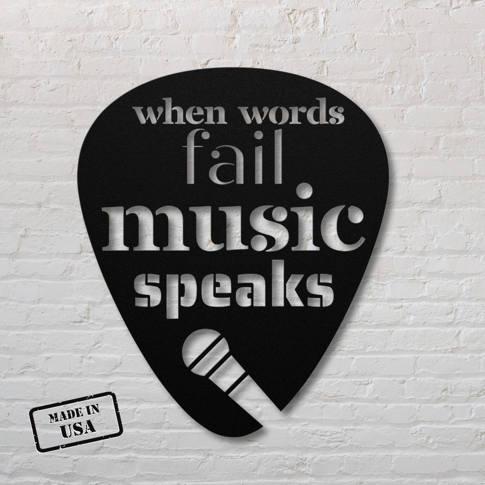 The "When Words Fail Music Speaks | Mic" sign features a black, powder-coated, guitar pick-shaped metal design with the words "when words fail music speaks" and an image of a microphone. Perfect for home decor, its "Made in USA" stamp is prominently displayed against a timeless white brick wall backdrop.