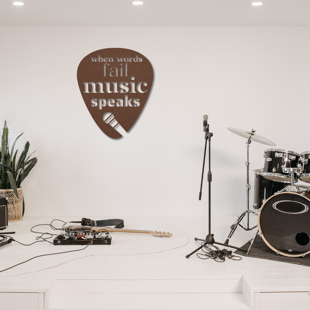 In the music studio, there's a powder-coated drum set, a microphone on a stand, and various pieces of guitar equipment scattered around. A charming metal sign in the shape of a guitar pick reads "When Words Fail Music Speaks," contributing to the home's decor. Indoor plants bring life to one corner.