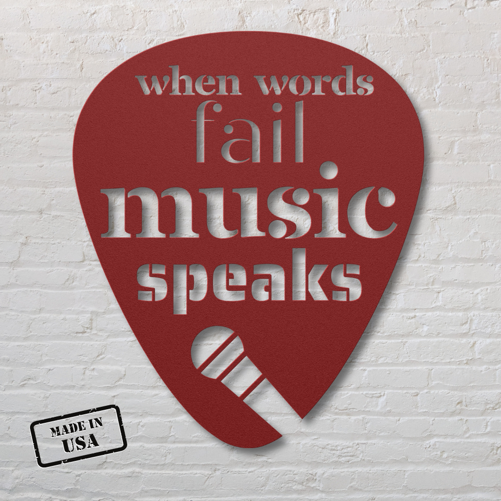 The "When Words Fail Music Speaks | Mic" is a maroon metal sign shaped like a guitar pick, powder-coated for durability. It features the phrase "when words fail, music speaks" cut out and includes a stylized microphone image at the bottom. A "Made in USA" stamp adds authenticity to its design, making it ideal for distinctive home decor against a white brick wall backdrop.
