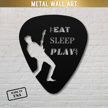 This Eat, Sleep, Play, Repeat Guitar Pick Metal Wall Art, crafted from durable powder-coated steel and made in the USA, is ideal as a gift for guitarists. Displayed against a white brick background, it features a silhouette of a guitarist along with the words "EAT SLEEP PLAY.