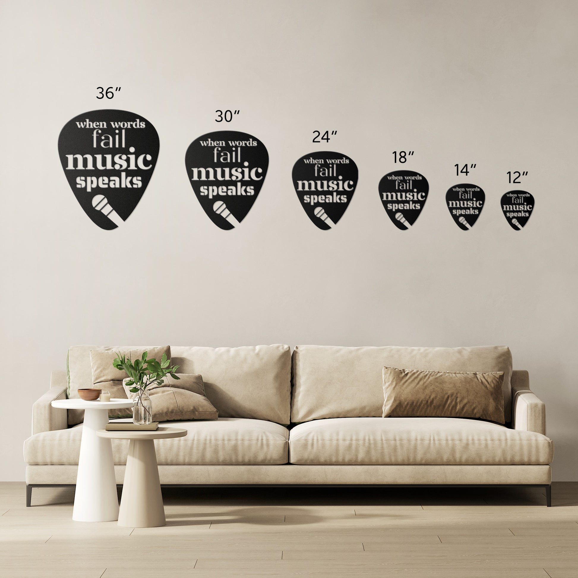 In a minimalist living room, a beige couch adorned with cushions is elegantly accompanied by a powder-coated metal sign overhead. This sign, featuring guitar pick-shaped accents and the phrase "When Words Fail Music Speaks | Mic," adds distinctive flair to the decor. A small side table nearby, topped with a plant and books, enhances the cozy atmosphere of the space.