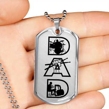 A close-up of a hand holding the Dad Text with Drummer Figures Dog Tag Necklace for Drummer—a military style necklace with "DAD" spelled by drummer silhouettes, making it a unique gift for any drummer dad.