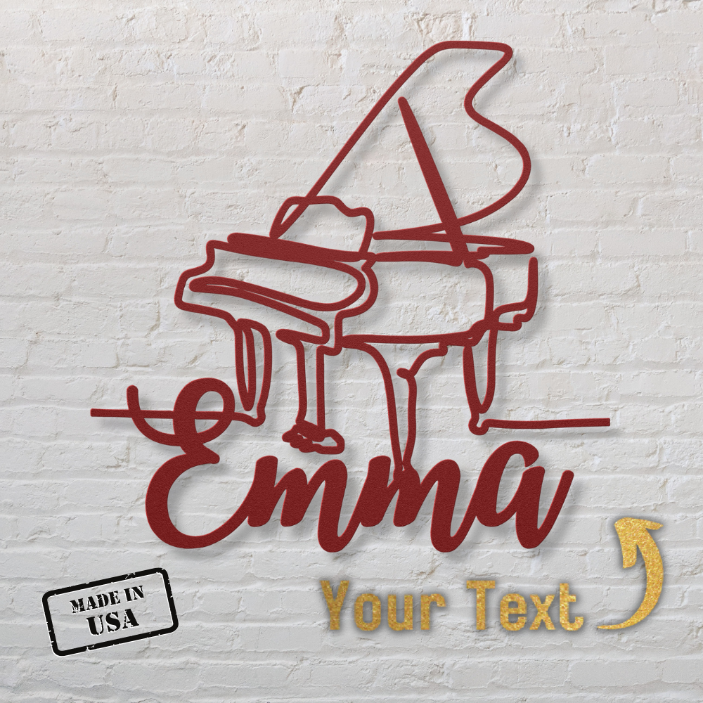 The Grand Piano Line-Art with Custom Name features a red outline of a grand piano and “Emma” in cursive on powder coated metal, set against a white brick wall. A gold arrow points to customizable text, with a “Made in USA” stamp at the bottom left.