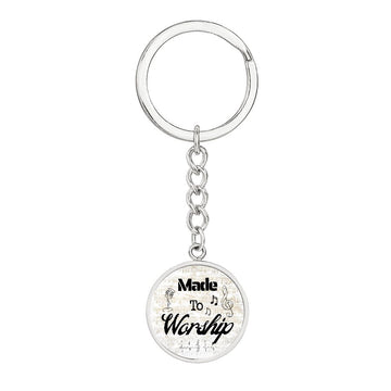 A personalized keychain with a round gold pendant reading "Made to Worship" and decorated with sheet music—perfect for singers or as a special gift for musicians.