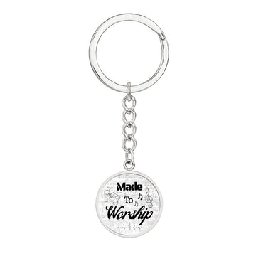 The Made to Worship Silver Sheet Music keychain features a round pendant with "Made to Worship" in black cursive, sheet music details, and drumsβa perfect gift for any drummer.