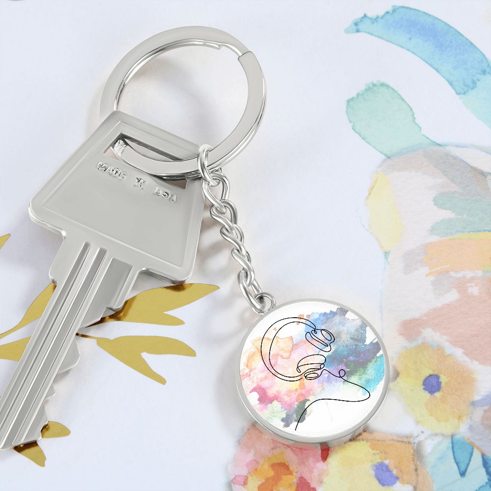 A Head Phones Colorful circle pendant keychain, featuring a vibrant design on a round charm, is the perfect personalized gift for any music lover.