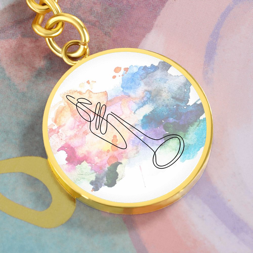 The Trumpet Colorful Circle Pendant Keychain features a gold round pendant with a vibrant watercolor background and minimal black trumpet line art—an ideal personalized gift for trumpetists.