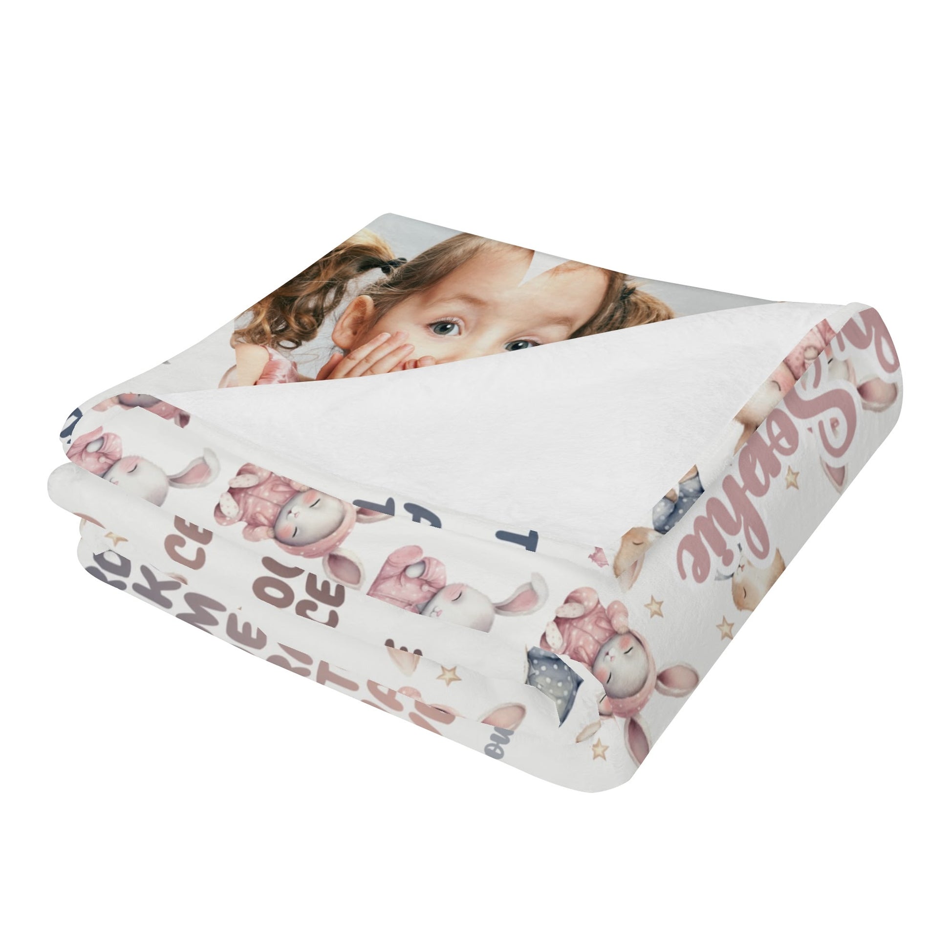 A personalized baby name blanket featuring a child's face with cartoon animals and letters. This predominantly white, custom photo blanket gift is embellished with pastel-colored illustrations, making it a delightful keepsake for occasions such as baptisms or baby showers.