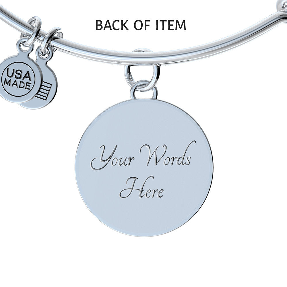 A Personalized Made to Worship Drums Round Pendant Bangle – Silver Sheet Music, featuring a round charm engraved with “Your Words Here” and a small tag that reads “USA MADE.” Thoughtfully crafted, this personalized drummer gift makes an ideal worship team appreciation keepsake. The text “BACK OF ITEM” appears above the charm.