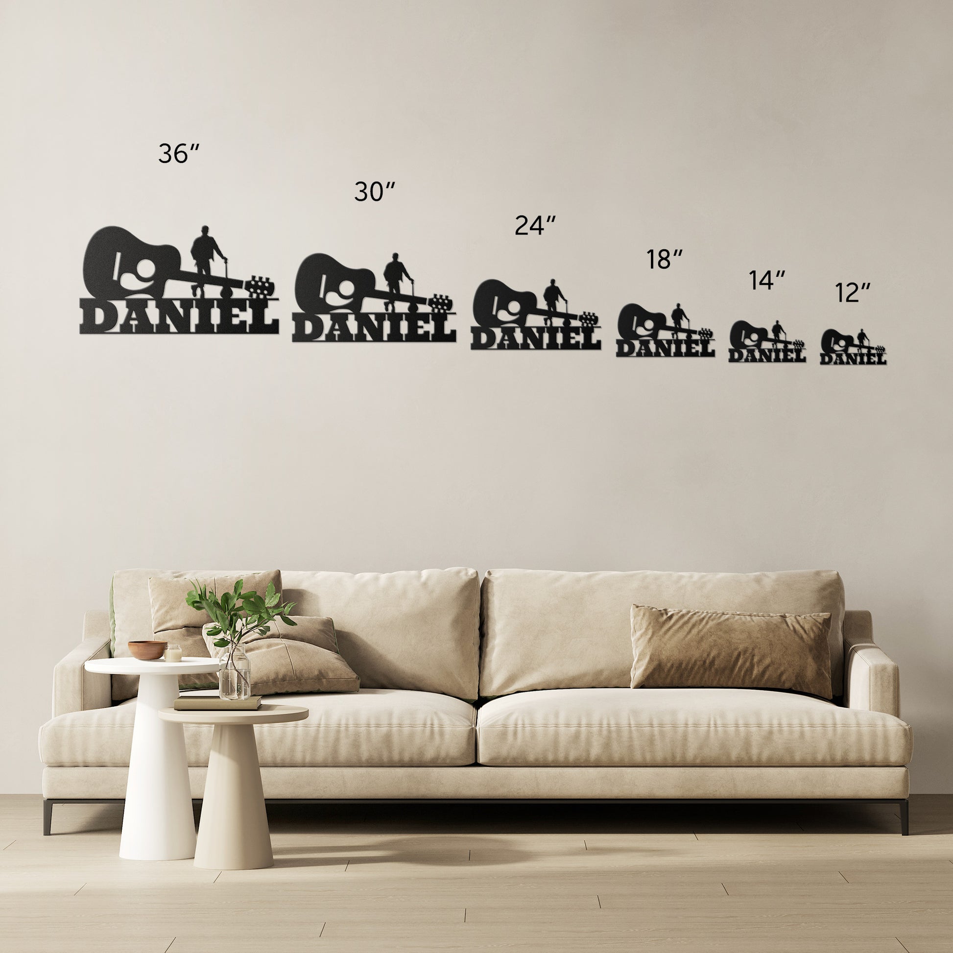 Personalized wall decals depicting the name "Daniel" in various sizes with a cute elephant and Acoustic Guitar with Guitarist Wall Sign Custom Name design, showcased above a sofa for scale reference.
