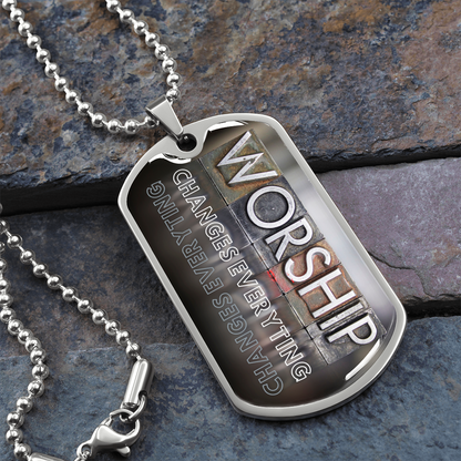 Silver worship dog tag necklace with bold vertical worship typography and “Worship Changes Everything” design on stone