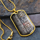 Gold-finish worship dog tag necklace featuring bold vertical worship typography and “Worship Changes Everything” on stone