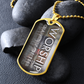 Gold military-style pendant necklace for a worshipper with bold vertical worship typography and “Worship Changes Everything”, beside black stones