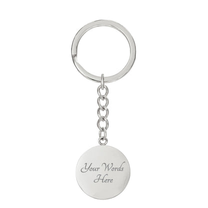 Brass musician keychain showing the round pendant back with sample custom engraving